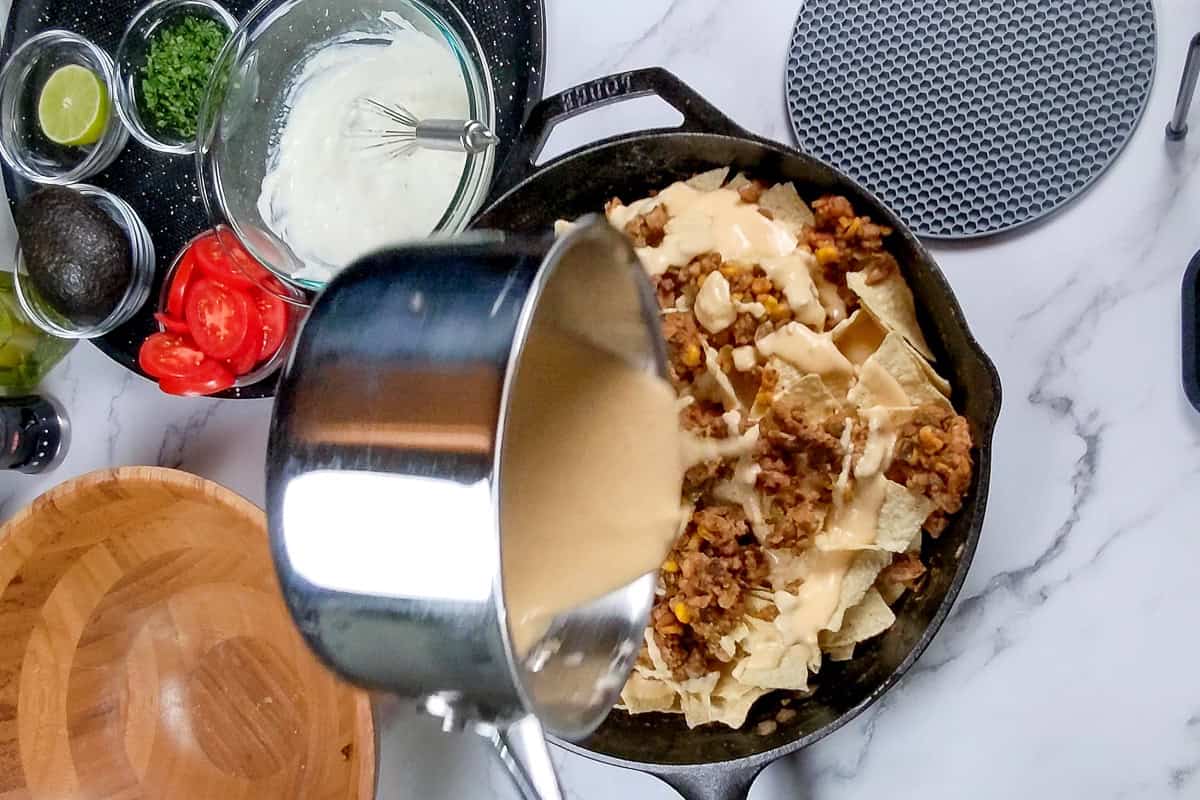 cheese sauce added to top of the layered tortilla chips and meat mixture.