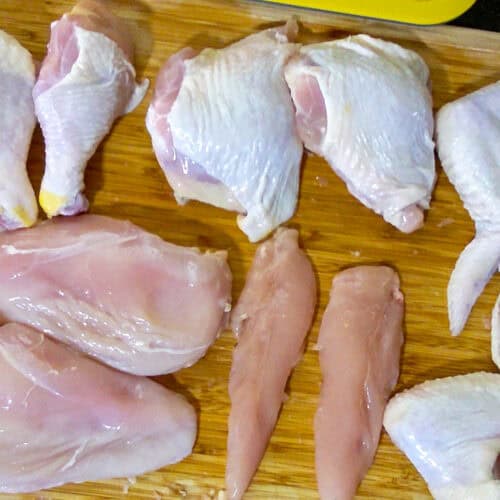 showcasing all of the chicken parts on the cutting board.