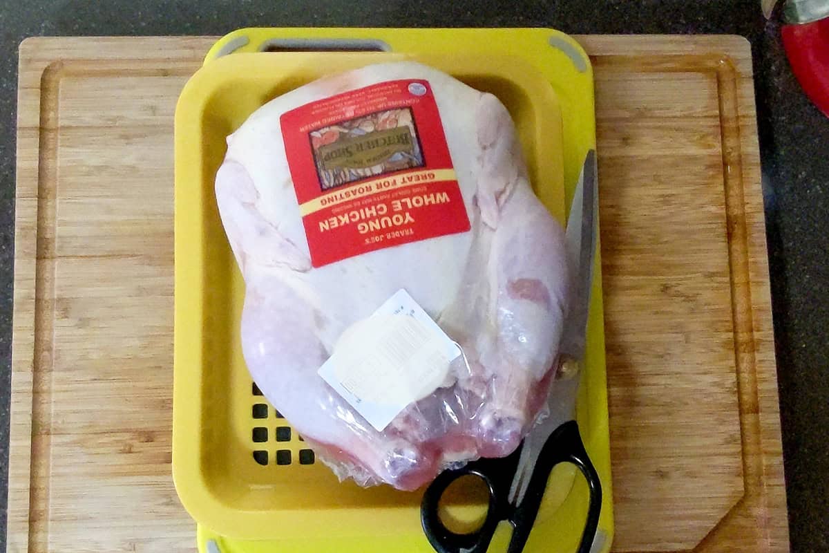packaged whole chicken on drip tray.