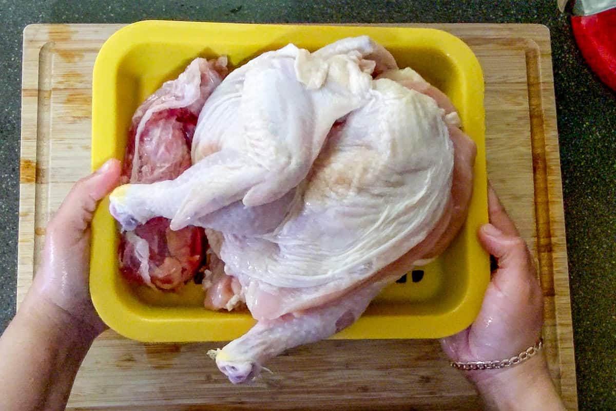 show casing the chicken halves on the drainage tray along with the giblet package.