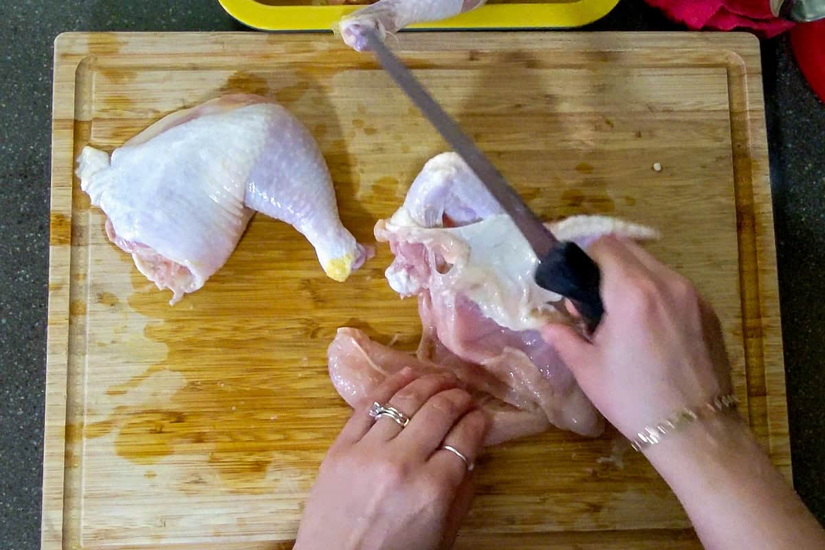 removing the chicken tenderloin from the chicken breast.