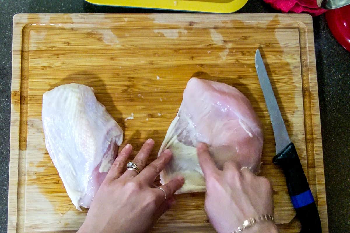 showing how to separate the chicken skin from the breast.