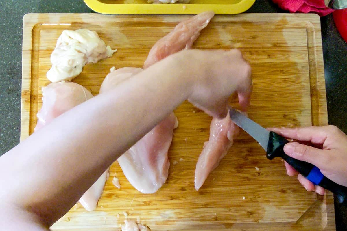 connective tissue being removed with a knife from the tenderloin.