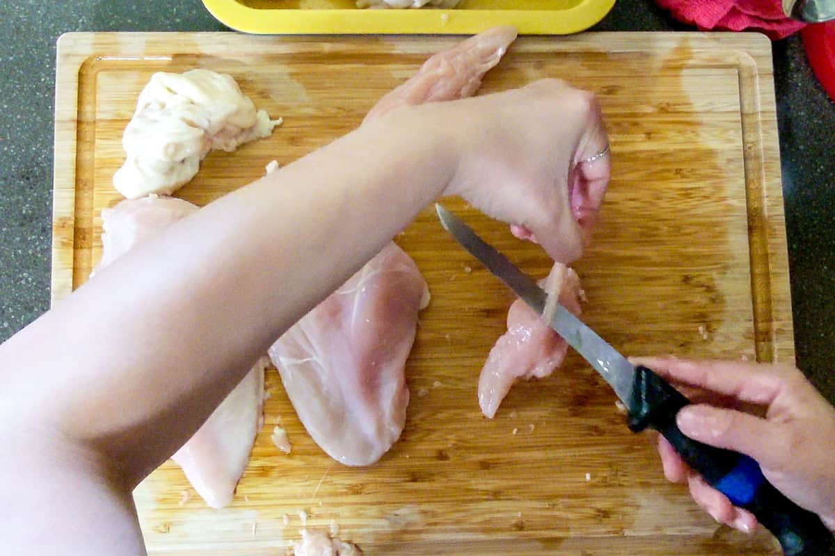 connective tissue being removed with a knife from the tenderloin.