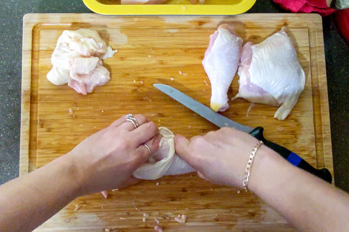 chef breaking the knee joint known as the hock joint between the leg and thigh.