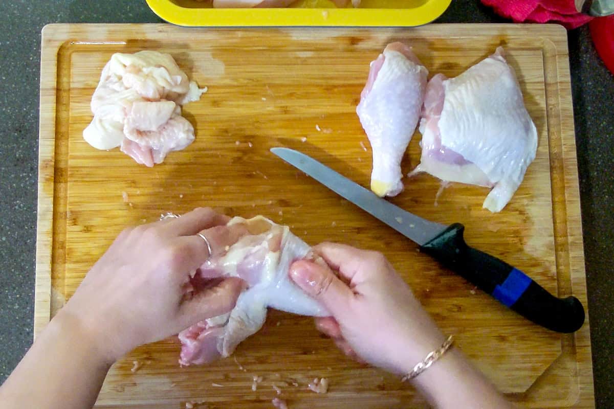 chef breaking the knee joint known as the hock joint between the leg and thigh.