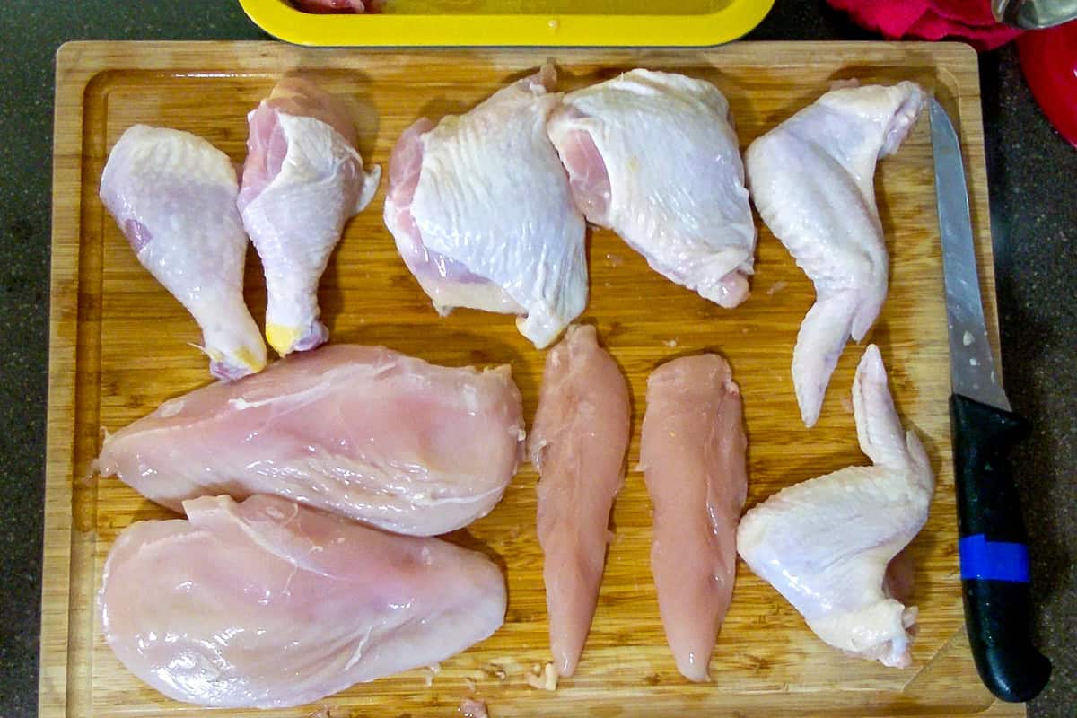 showcasing all of the chicken parts on the cutting board.