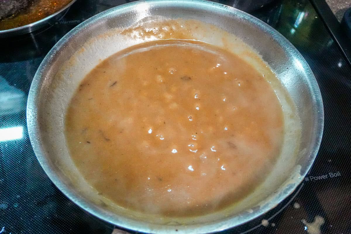 gravy simmering in a saute pan.
