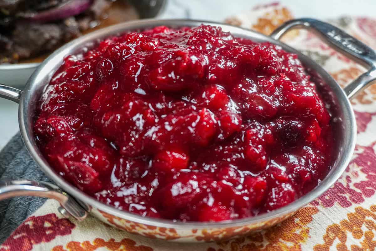 close up of the Fresh Cranberry Ginger Chutney in an all-clad mini pan.