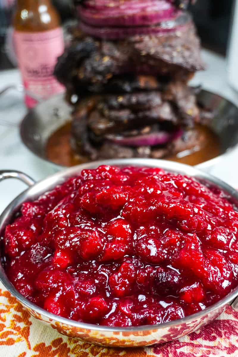 close up of the Fresh Cranberry Ginger Chutney with beiutui marinaded steak shawarma in the background.