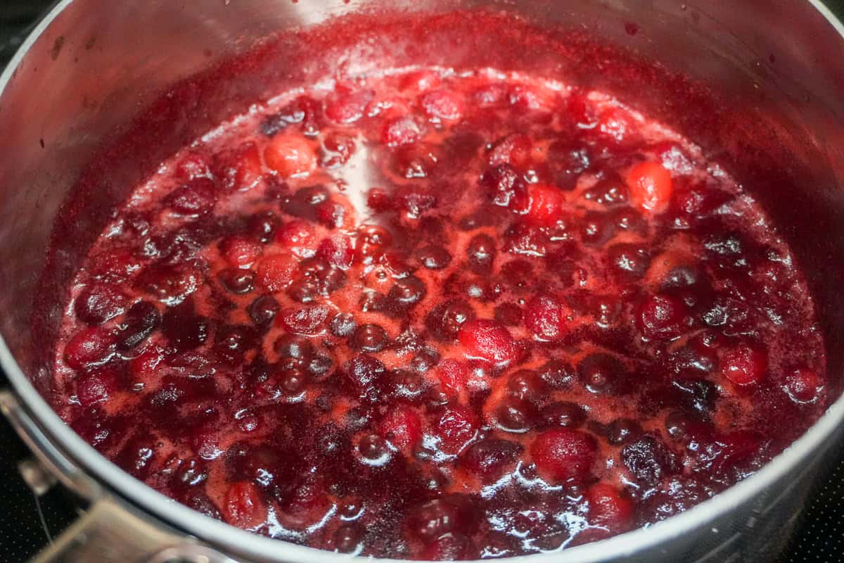 simmering finished cranberry chutney in a saucepan.