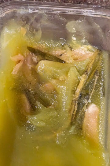 solidified garlic confit in a glass container.