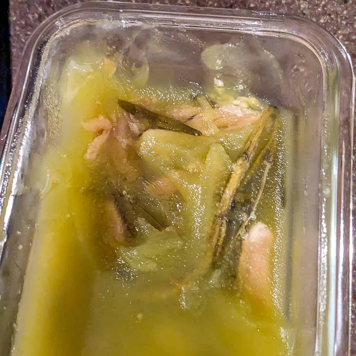 solidified garlic confit in a glass container.