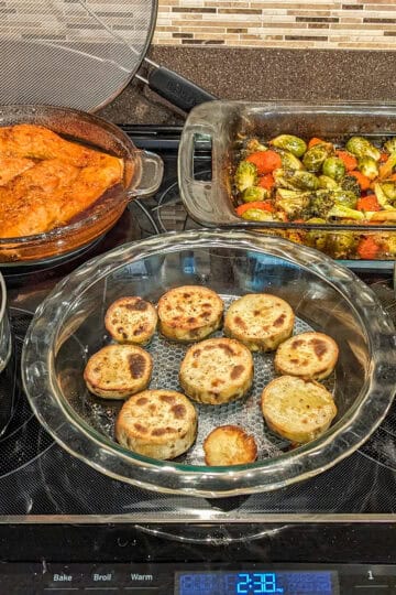 5 prepared dishes on a stove.