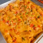 aked Haitian Macaroni and Cheese with Diced Ham, Red Bell Pepper, and Cheeses in a baking dish.