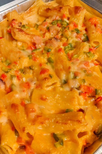 aked Haitian Macaroni and Cheese with Diced Ham, Red Bell Pepper, and Cheeses in a baking dish.