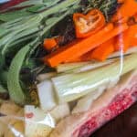 Mirepoix-Based Backbone Turkey Gravy with Haitian Spices in a resealable bag.