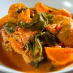 close up of the West African Peanut Stew with Chicken and Collard Greens in a wide rim bowl.