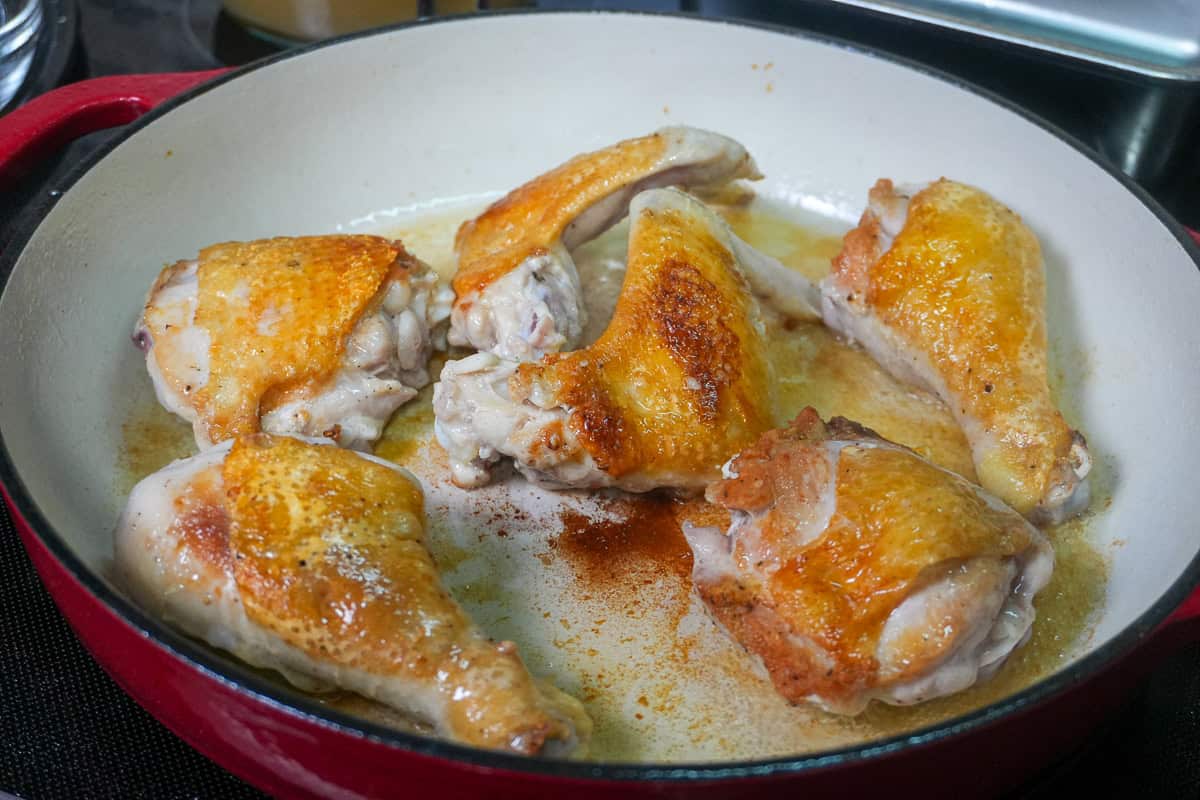 golden brown chicken seared in a dutch oven.