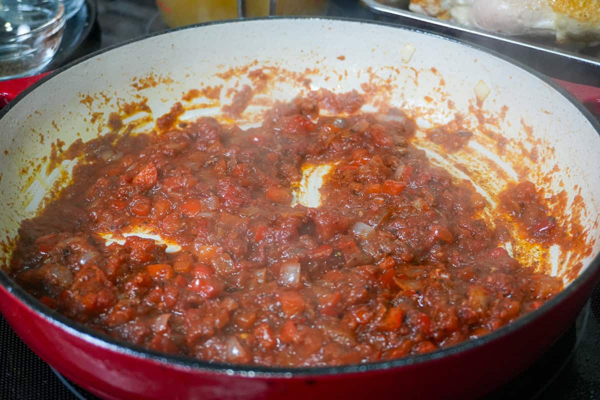 aromatics and tomato paste mixture frying in a dutch oven.