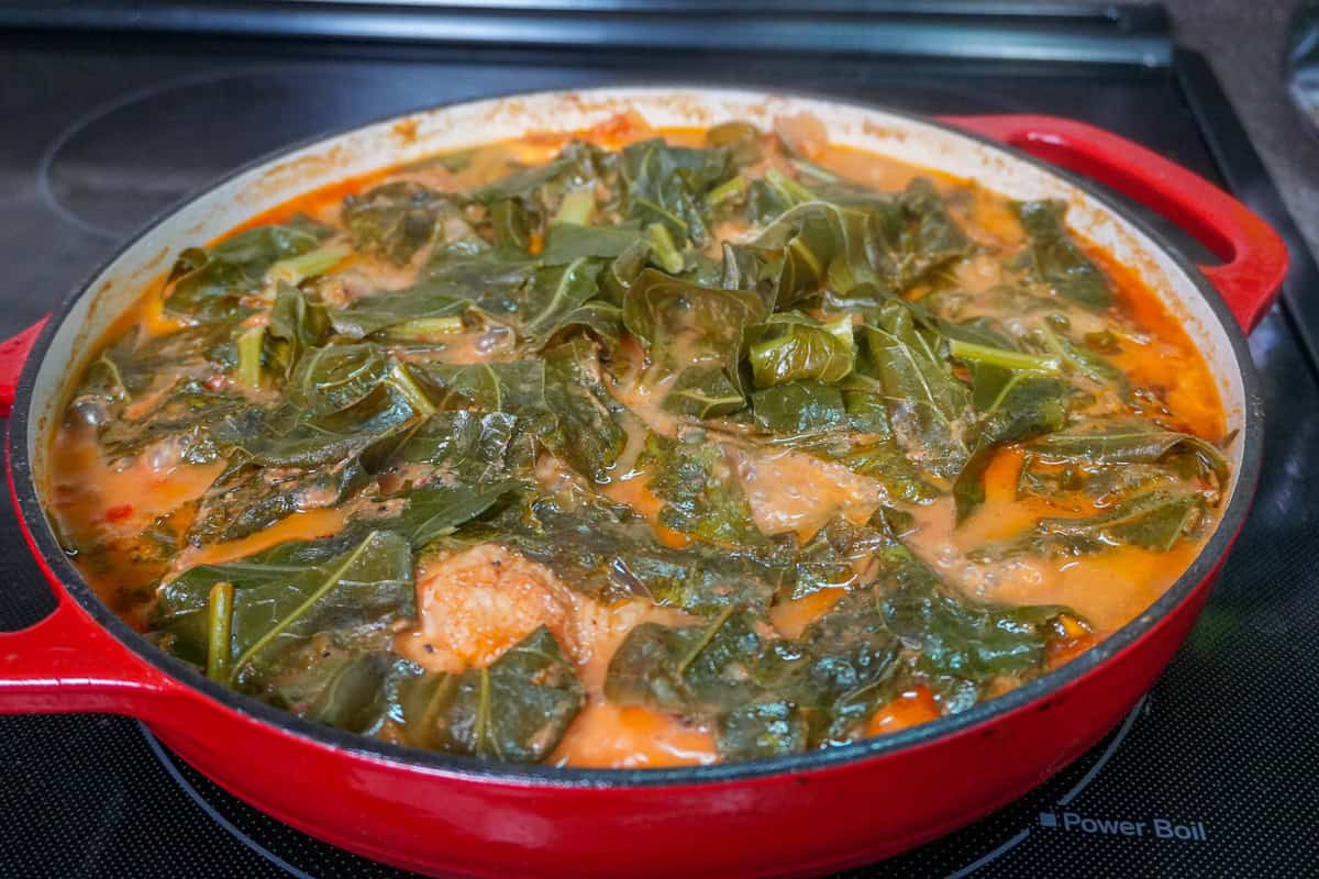 simmered peanut Stew with Chicken and Collard Greens in a cast iron dutch oven.