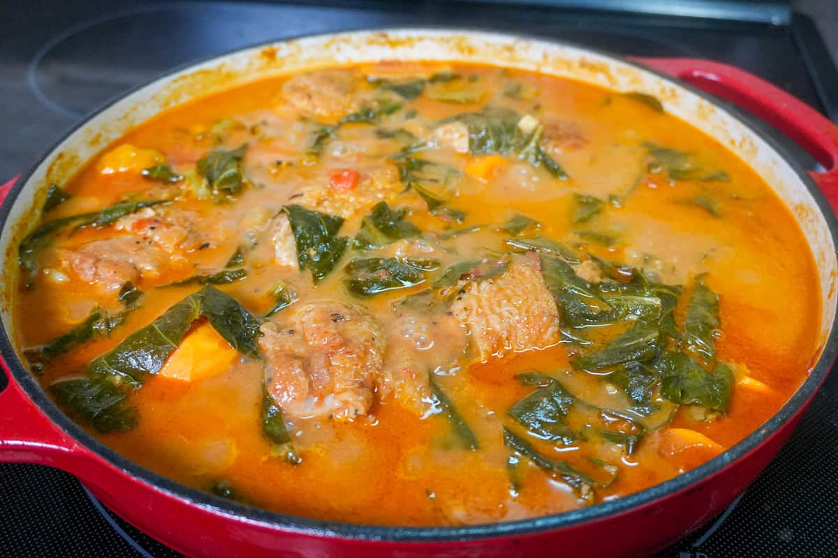 simmered peanut Stew with Chicken and Collard Greens in a cast iron dutch oven.