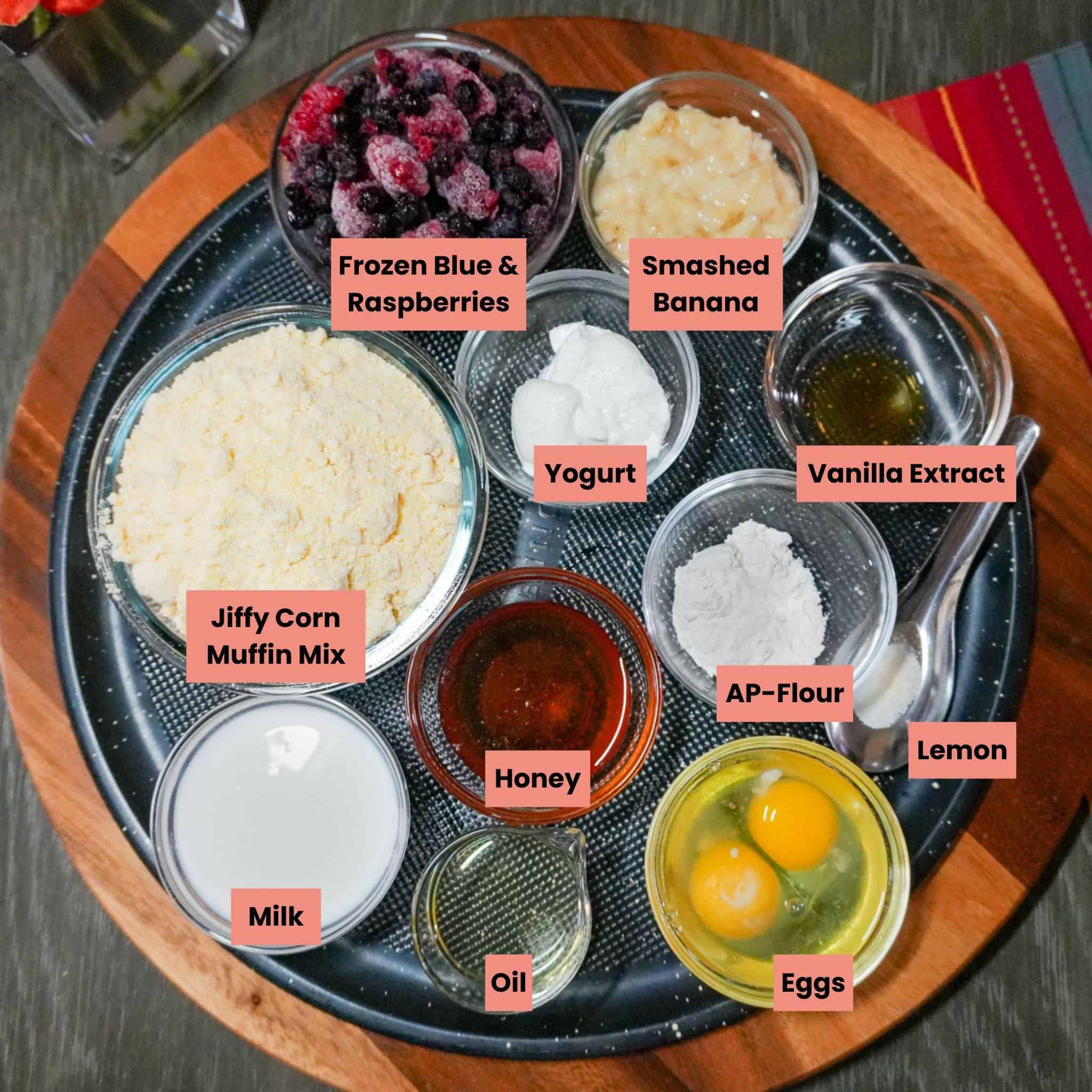 labeled ingredients for the Banana Berry Corn Muffins with Yogurt on a round tray.