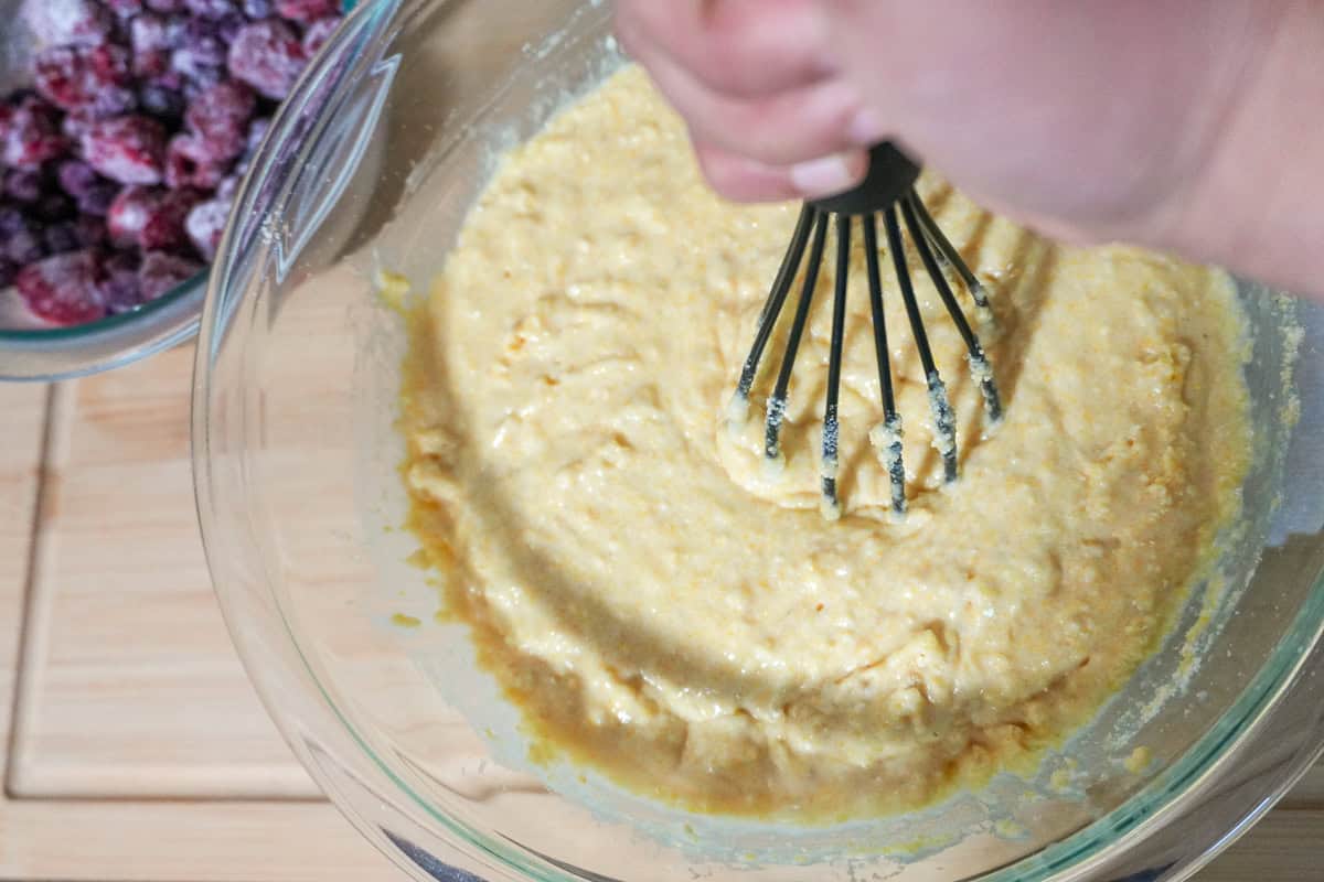 whisk breaking clumps for the Banana Berry Corn Muffins with Yogurt batter.