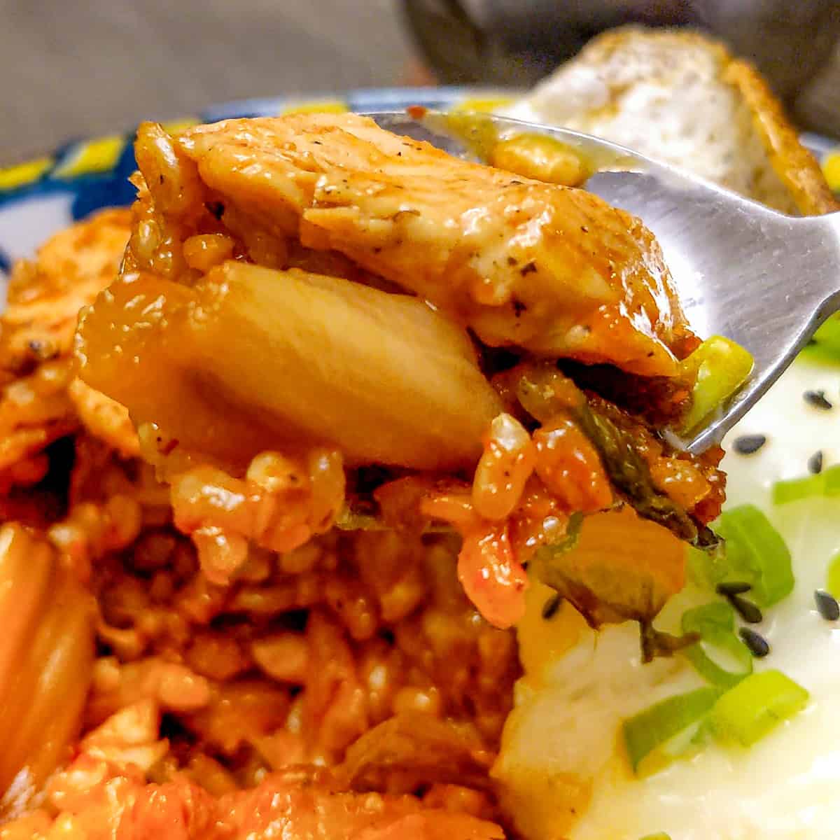 close up of chicken kimchi rice on a spoon.