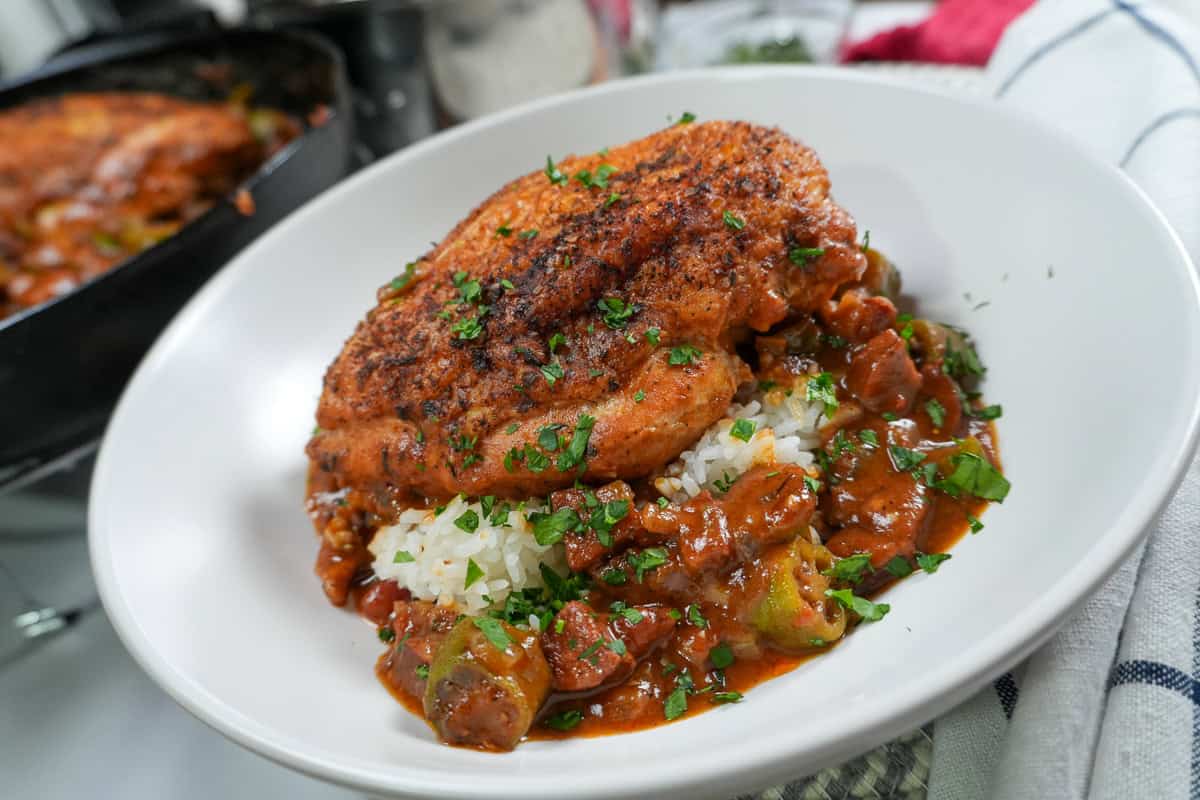 close up plate up of the Pan-Roasted Chicken and Andouille Sausage Gumbo in a wide rim bowl.