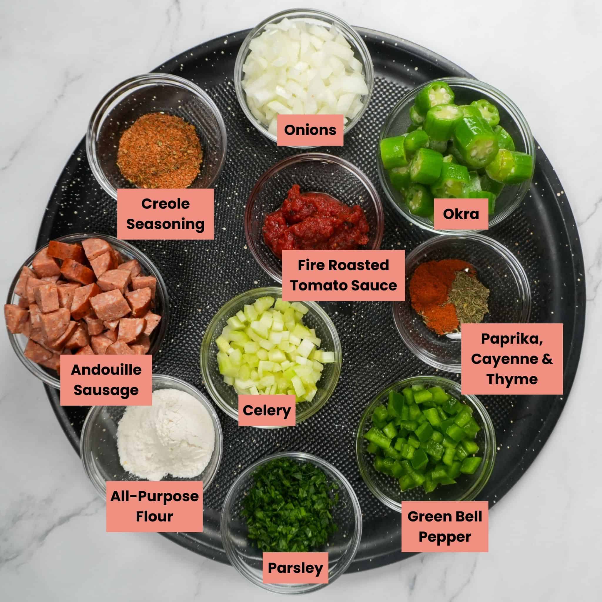 ingredients for the Pan-Roasted Chicken and Andouille Sausage Gumbo on a round tray.