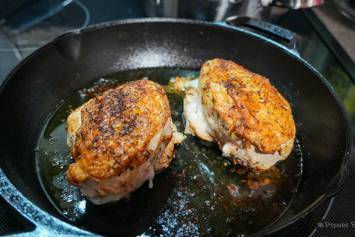 skin on chicken breast seared in a lodge cast iron pan.