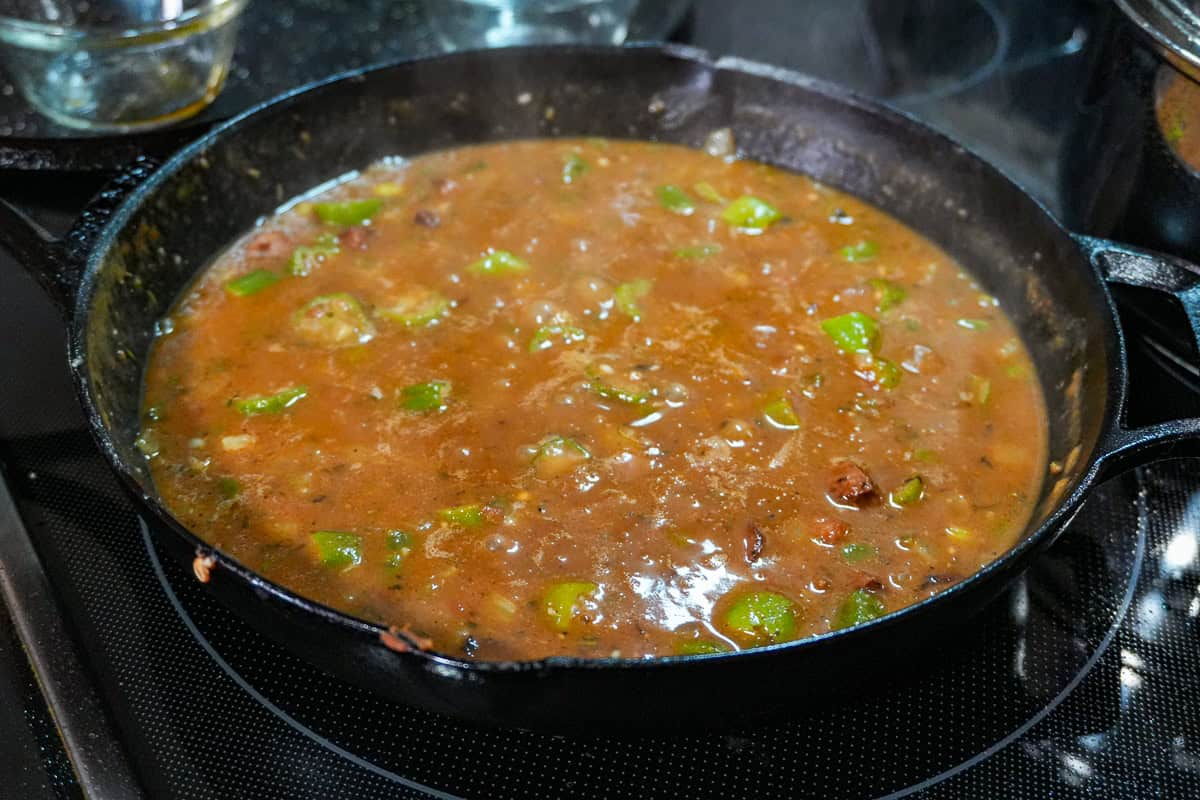 simmering gumbo in a cast iron skillet.