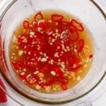 nouc cham sauce in a glass container.