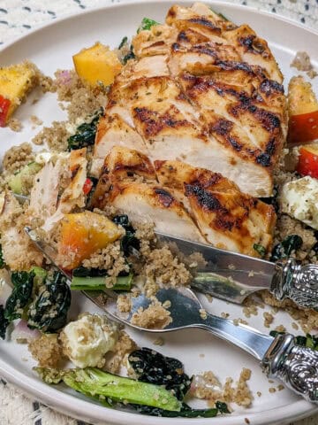 Grilled Chicken with Peach Fonio and greens salad with peach piri piri dressing.