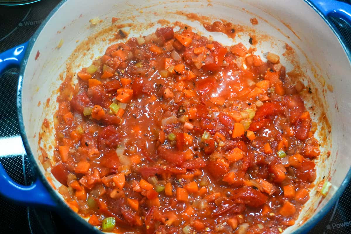 mirepoix and, tomato sauce, fresh tomatoes and calabrian chili peppers in a dutch oven.