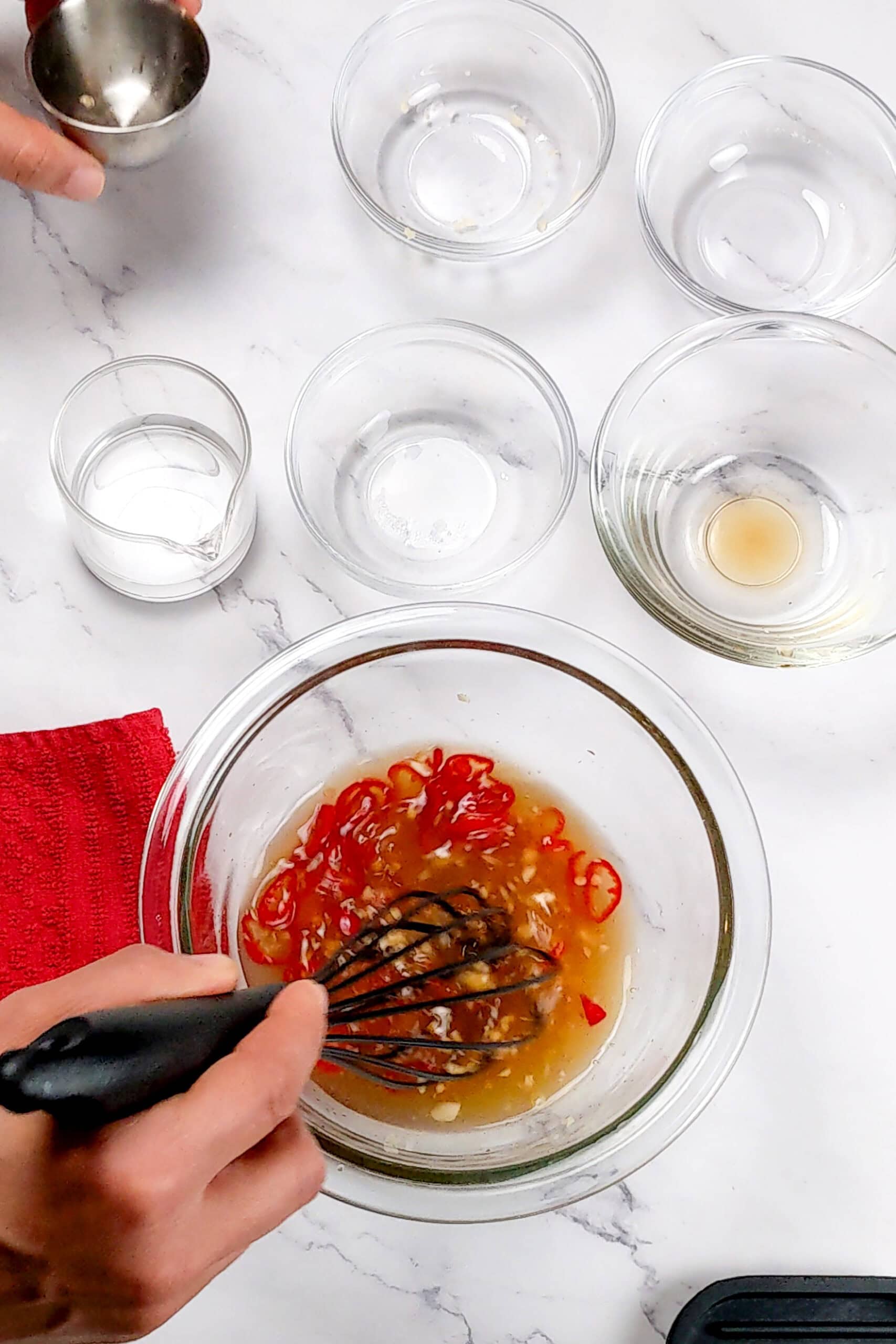 all ingredients in the mixing bowl being whisked to make the Nuoc Cham Sauce recipe.
