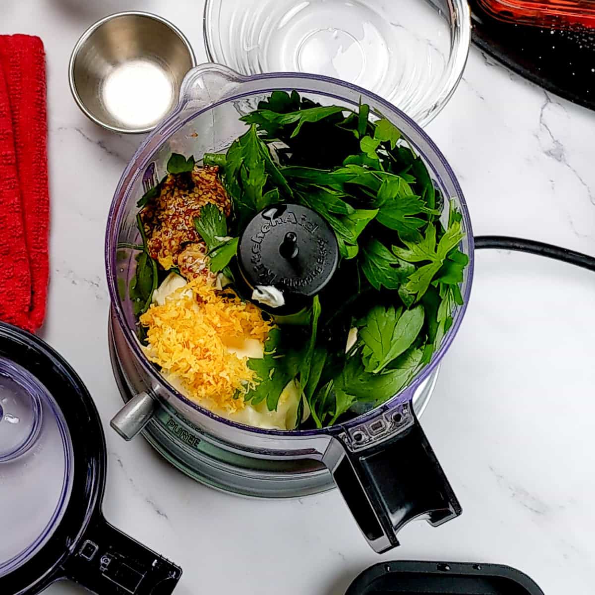 ingredients for the Lemon Dijon Mustard Remoulade in a food chopper.