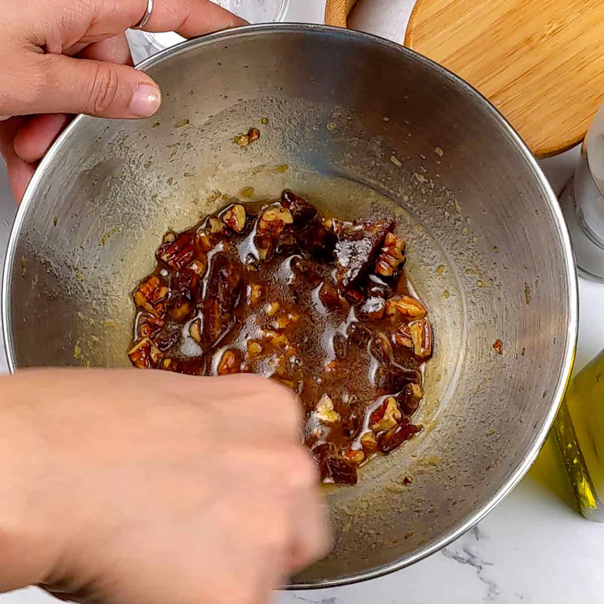 Date Pecan Pomegranate Vinaigrette in a bowl being mixed.