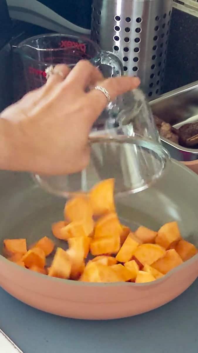 large chunks of sweet potatoes aka yams poured into a saute pan.