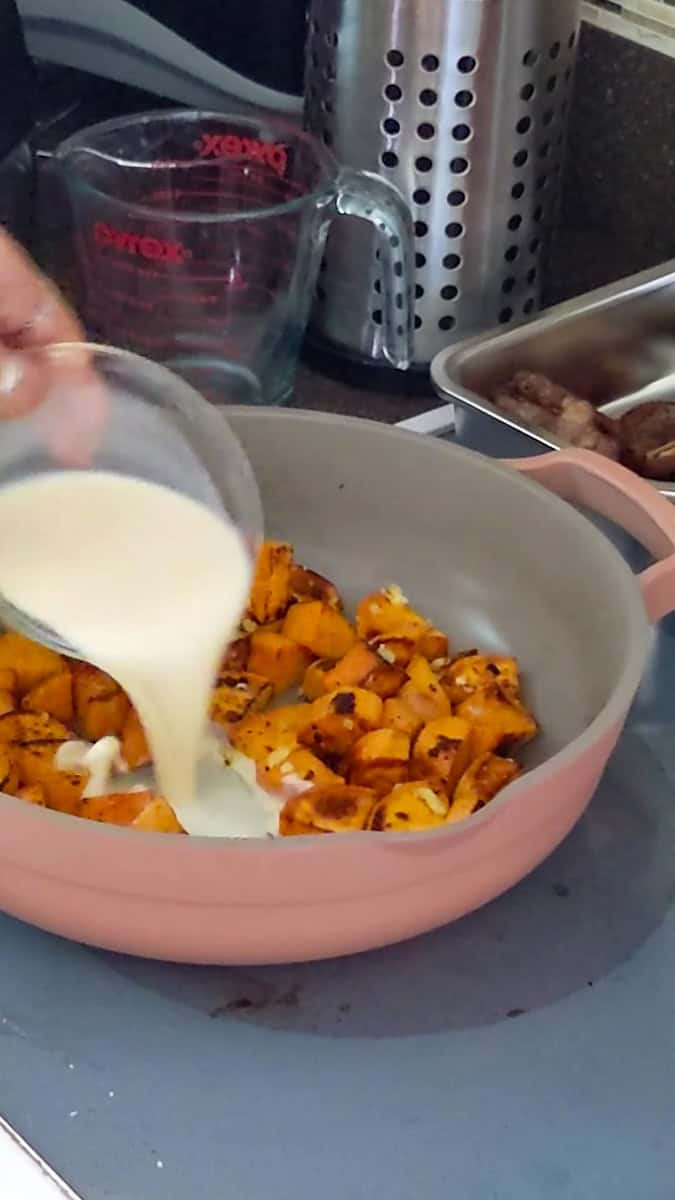 coconut milk added to cooked browned sweet potatoes.
