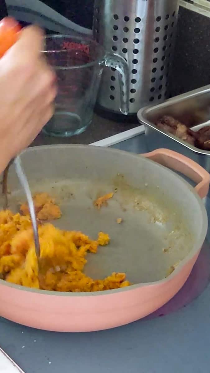 coconut milk sweet potatoes mashed with a potato masher.