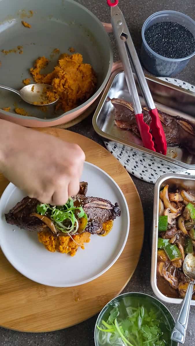 garnishing the Trader Joe's Korean Short Ribs Recipe with Sweet Potatoes.