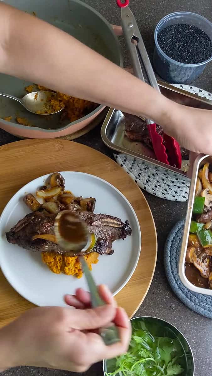 saucing the Trader Joe's Korean Short Ribs Recipe with Sweet Potatoes.