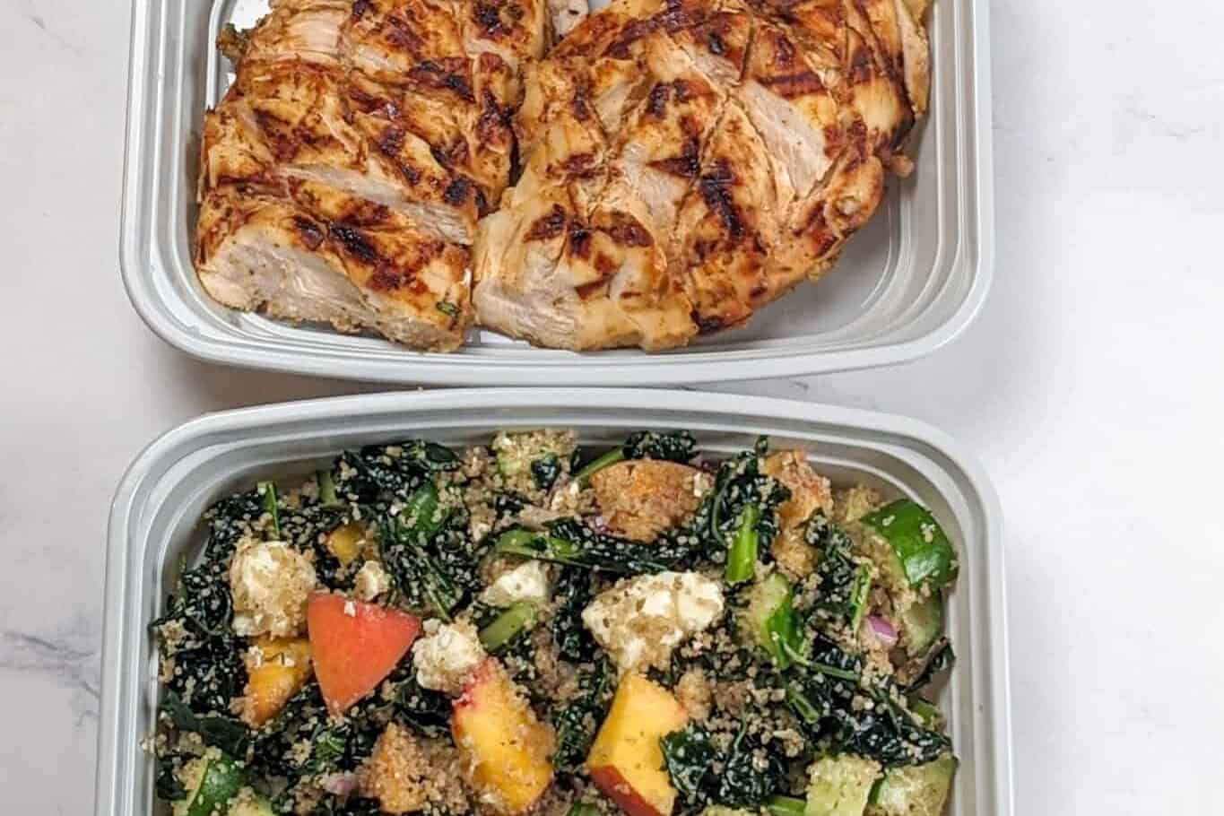 two meal prep food containers. one with grilled chicken and another with kale salad.