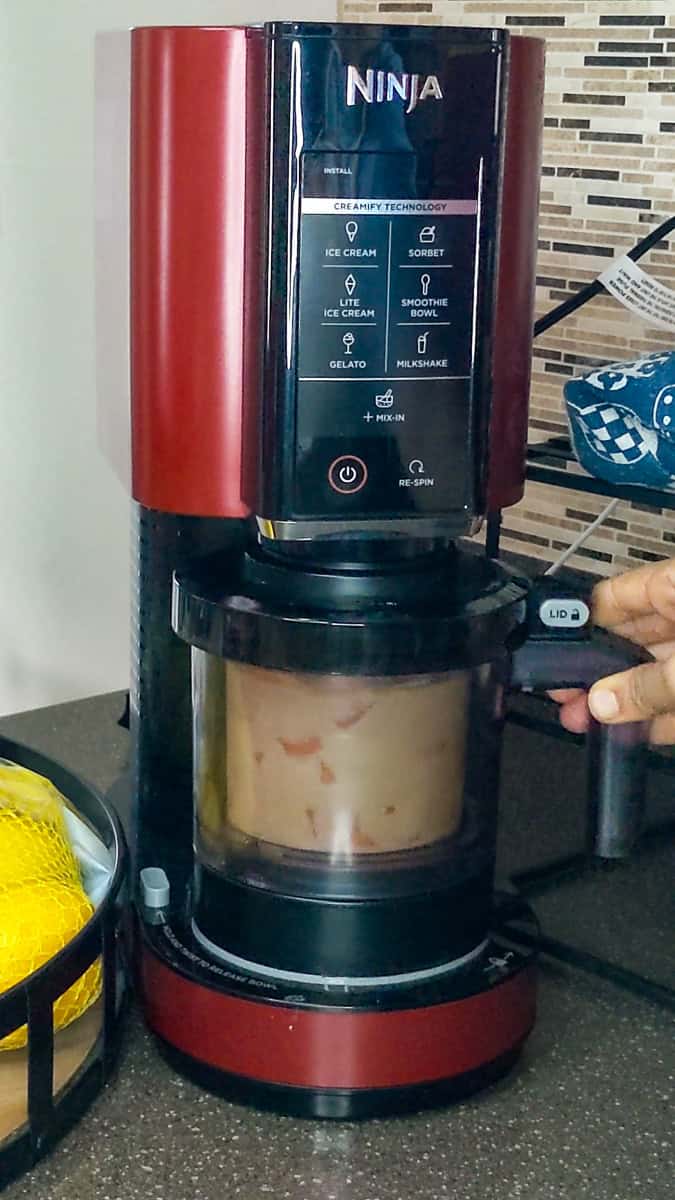 placing the ice cream base into the ninja creami machine.