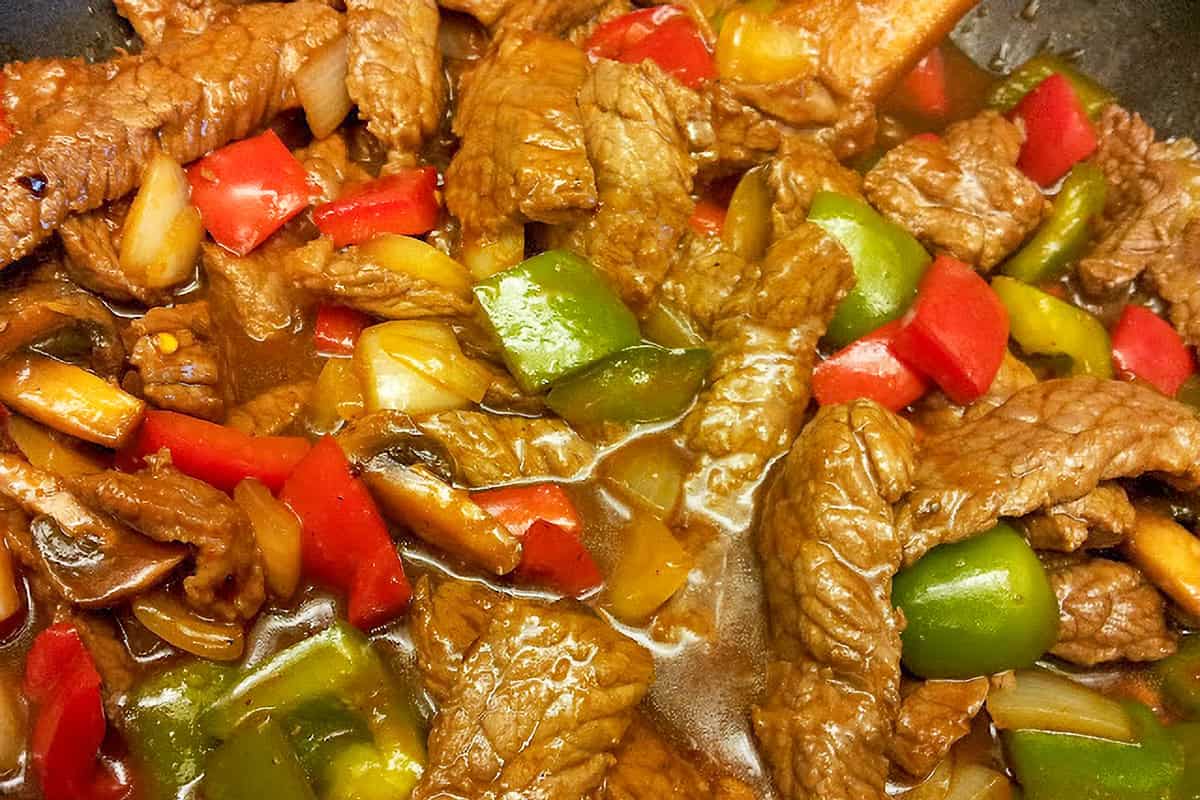 Chinese pepper steak recipe with red wine, hoisin sauce, bell peppers, and mushrooms.