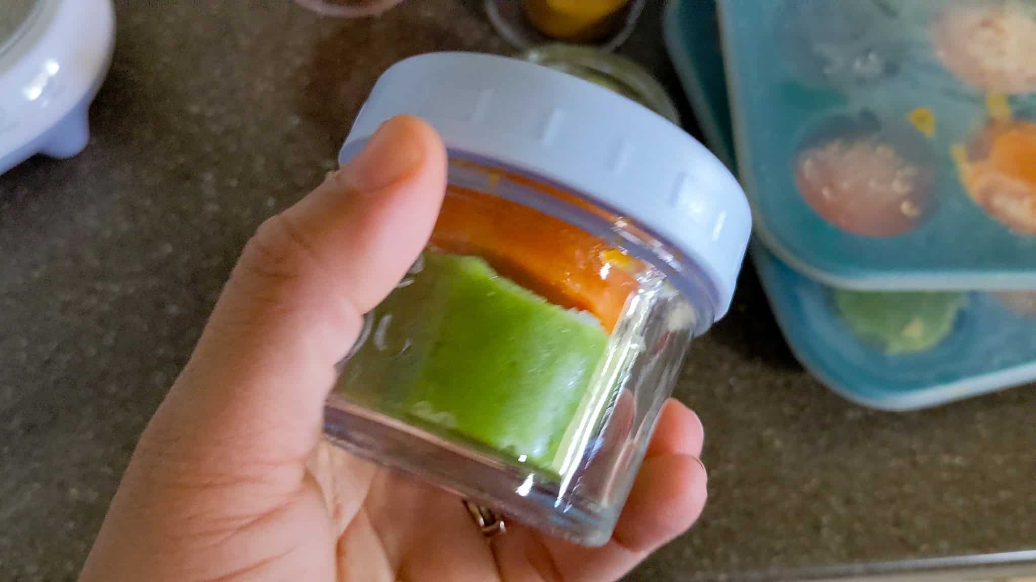 weesprout glass baby food jar with a portion of frozen broccoli and carrot.