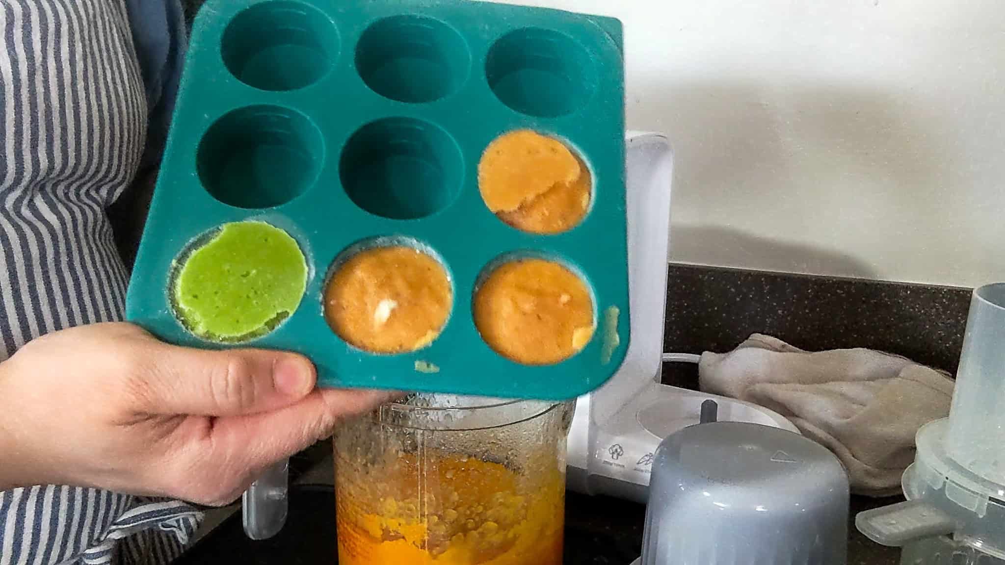 frozen partions of pureed of 3 sweet potato and 1 green pea in an anytime freezer tray.