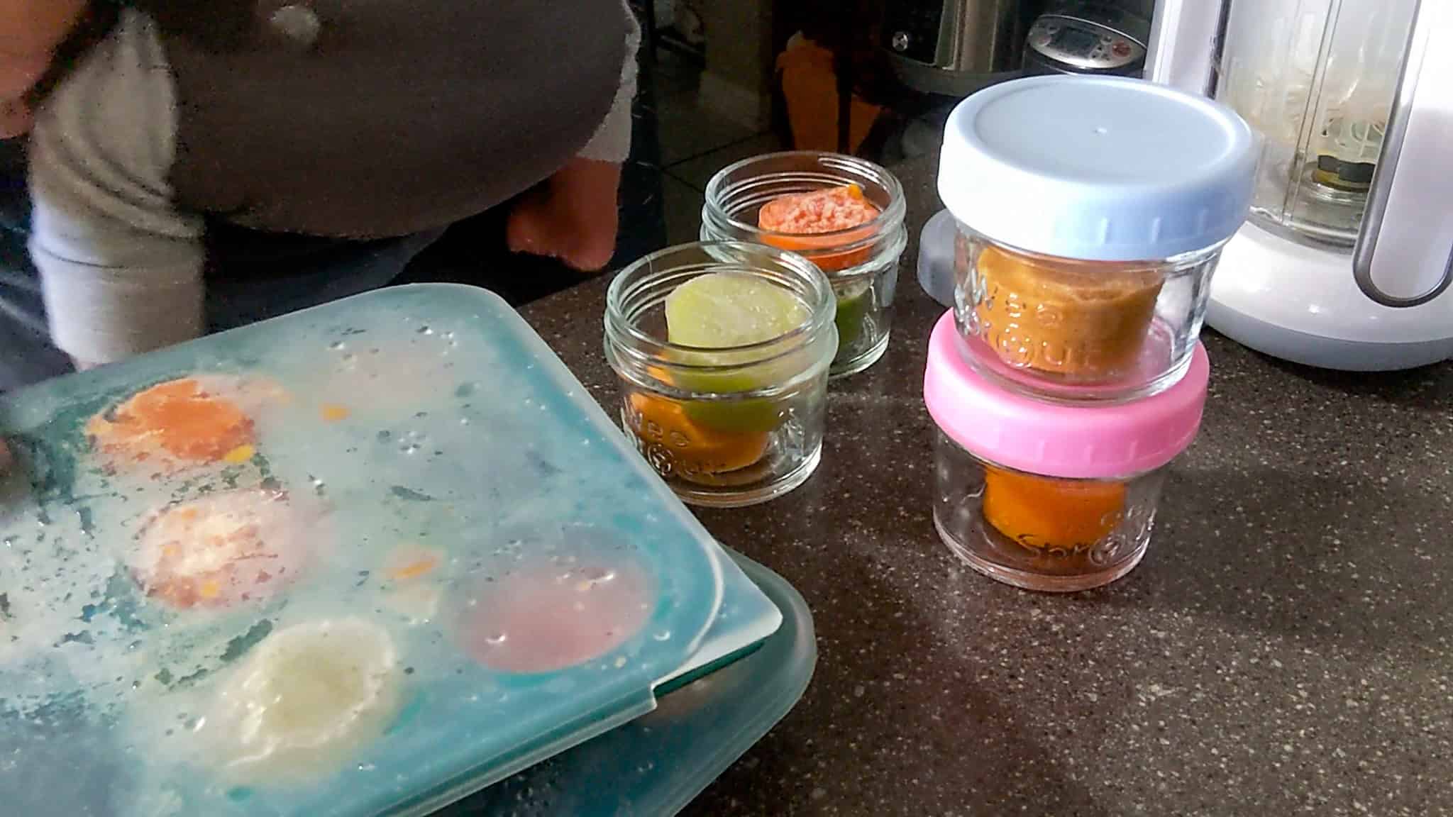 WeeSprout Glass Baby Food Storage Jars filled with frozen portioned baby food next to Anytime Freezer Trays.